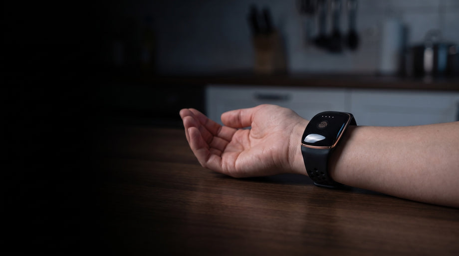 A palm-up forearm on a dark counter with the SteadyWave band on the wrist